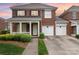 Charming brick home with a welcoming front porch and a two-car garage at 20015 N Cove Rd, Cornelius, NC 28031