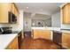 Bright kitchen featuring light wood cabinets, modern appliances, and hardwood floors at 20015 N Cove Rd, Cornelius, NC 28031
