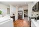 Well-lit kitchen with stainless steel appliances, white cabinetry, and hardwood flooring at 20015 N Cove Rd, Cornelius, NC 28031