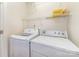 Convenient laundry room equipped with a washer, dryer, and shelving for storage at 20015 N Cove Rd, Cornelius, NC 28031