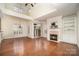 Bright living room with vaulted ceilings, a fireplace, built-in shelving, and hardwood floors at 20015 N Cove Rd, Cornelius, NC 28031