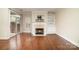 Spacious living room features a fireplace, built-in shelves, and glass doors to an outdoor area at 20015 N Cove Rd, Cornelius, NC 28031