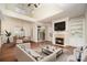 Bright living room with fireplace, built-in shelving, hardwood floors, and high ceilings at 20015 N Cove Rd, Cornelius, NC 28031