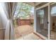 Private brick patio featuring a brick wall, lush greenery, and access to the home's interior at 20015 N Cove Rd, Cornelius, NC 28031