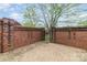 Private brick patio with a decorative gate, offering a secluded outdoor retreat at 20015 N Cove Rd, Cornelius, NC 28031