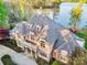 Luxury lakefront home featuring an expansive roof, manicured landscaping, and waterfront views at 210 Dexter Ave, Kannapolis, NC 28081