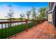 Spacious back deck featuring wood flooring and a decorative railing, offering scenic views of the lake at 210 Dexter Ave, Kannapolis, NC 28081