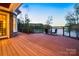 Relaxing outdoor space featuring a wooden deck, stylish railings, and a cozy table with chairs overlooking a serene lake at 210 Dexter Ave, Kannapolis, NC 28081