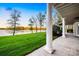 Beautiful backyard featuring a lush lawn, lake views, and a covered patio at 210 Dexter Ave, Kannapolis, NC 28081