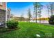 Picturesque backyard with lush lawn, mature trees, and peaceful lake frontage at 210 Dexter Ave, Kannapolis, NC 28081