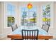 Breakfast nook featuring bright windows with scenic view of the lake, modern table, and black chairs at 210 Dexter Ave, Kannapolis, NC 28081