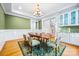 Bright dining room with decorative rug, hardwood floors, modern lighting, and green accent wall at 210 Dexter Ave, Kannapolis, NC 28081