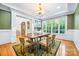 Elegant dining room with a large window, hardwood floors, and classic chandelier at 210 Dexter Ave, Kannapolis, NC 28081