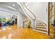 Bright foyer featuring hardwood floors, curved staircase, and living room with fireplace at 210 Dexter Ave, Kannapolis, NC 28081