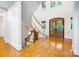Inviting foyer with hardwood floors, a curved staircase, and a solid wood front door at 210 Dexter Ave, Kannapolis, NC 28081