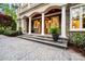 Elegant stone front entrance with stately columns, a wood door, and manicured landscaping at 210 Dexter Ave, Kannapolis, NC 28081