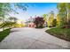 Spacious three-car garage with a concrete driveway and landscaping in a wooded area at 210 Dexter Ave, Kannapolis, NC 28081