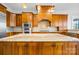 This kitchen has granite countertops, a stone backsplash, stainless steel appliances, and wood cabinets at 210 Dexter Ave, Kannapolis, NC 28081
