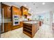 Spacious kitchen boasts a central island, stainless appliances, custom cabinets, and a travertine tile floor at 210 Dexter Ave, Kannapolis, NC 28081