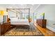 Main bedroom boasts a four-poster bed, hardwood floors, and large windows with bay window area at 210 Dexter Ave, Kannapolis, NC 28081