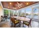 Relaxing sunroom with lake view, wood ceiling with fans, and dining and lounge seating at 210 Dexter Ave, Kannapolis, NC 28081