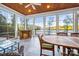 Gorgeous sunroom with stone fireplace, lake views, wood ceiling, and travertine flooring at 210 Dexter Ave, Kannapolis, NC 28081