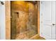 Luxurious walk-in shower featuring patterned tile, a glass door, and a built-in seat at 210 Dexter Ave, Kannapolis, NC 28081