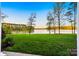 Inviting waterfront view showcasing pristine lawn stretching out towards tranquil lake waters and distant treeline at 210 Dexter Ave, Kannapolis, NC 28081