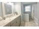This bathroom features a sleek vanity with plentiful natural light at 217 Windsor Dr, Shelby, NC 28150
