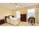 This bedroom is brightly lit with a ceiling fan and plentiful natural light at 217 Windsor Dr, Shelby, NC 28150