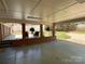 Covered patio with brick columns, ferns, and outdoor seating overlooks the backyard, ideal for relaxing at 217 Windsor Dr, Shelby, NC 28150