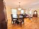 Open concept dining room features a dark wood dining table with seating for six with chandelier above at 217 Windsor Dr, Shelby, NC 28150
