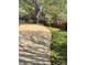 Long driveway beside a lush lawn and brick wall leading to a house surrounded by mature trees at 217 Windsor Dr, Shelby, NC 28150