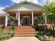 Inviting front porch with American flag, rocking chairs, and hanging plants, creating a welcoming entrance at 217 Windsor Dr, Shelby, NC 28150