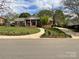 Charming single-story brick home featuring a landscaped front yard, sidewalk and inviting front porch at 217 Windsor Dr, Shelby, NC 28150
