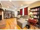 Comfortable living room featuring wood burning brick fireplace, ceiling fan, and hardwood floors at 217 Windsor Dr, Shelby, NC 28150