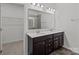 Bathroom featuring a double vanity with dark cabinets and a large mirror at 224 Old Harbor Dr, Mount Gilead, NC 27306
