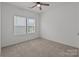 Bedroom features neutral walls, plush carpet, ceiling fan, and a window for bright, natural light at 224 Old Harbor Dr, Mount Gilead, NC 27306
