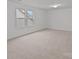 Spacious bedroom with neutral carpet and natural light from two windows at 224 Old Harbor Dr, Mount Gilead, NC 27306