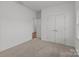 Spacious bedroom with plush carpet, neutral walls, and double doors leading to closet space at 224 Old Harbor Dr, Mount Gilead, NC 27306