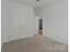 Bedroom offers plush carpeting, neutral walls, ceiling fan, and closet with double doors at 224 Old Harbor Dr, Mount Gilead, NC 27306