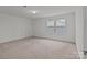 Bedroom featuring two windows and neutral carpet at 224 Old Harbor Dr, Mount Gilead, NC 27306