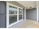 Inviting entryway featuring a glass-paneled front door and sleek gray siding, providing a welcoming first impression at 224 Old Harbor Dr, Mount Gilead, NC 27306