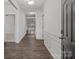 Inviting hallway with wood floors and white wainscoting leads to a bright, open living space at 224 Old Harbor Dr, Mount Gilead, NC 27306
