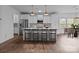 Modern kitchen with white cabinets, pendant lighting, stainless steel appliances, and a center island with bar stools at 224 Old Harbor Dr, Mount Gilead, NC 27306