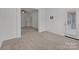 Open-concept living area with plush carpeting, access to back door, and seamless flow to other rooms at 224 Old Harbor Dr, Mount Gilead, NC 27306