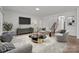 Comfortable living room includes contemporary furnishings, a large screen television, and staircase access at 224 Old Harbor Dr, Mount Gilead, NC 27306