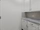 Bright mudroom boasts white cabinets, sleek hardware, gray countertops and backsplash, offering stylish storage at 224 Old Harbor Dr, Mount Gilead, NC 27306
