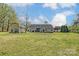 Expansive backyard showcases green lawn, storage shed, and inviting deck, ideal for outdoor enjoyment at 239 Bradford Glyn Dr, Mooresville, NC 28115