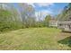 Expansive backyard featuring a lush green lawn and mature trees, perfect for outdoor activities and relaxation at 239 Bradford Glyn Dr, Mooresville, NC 28115